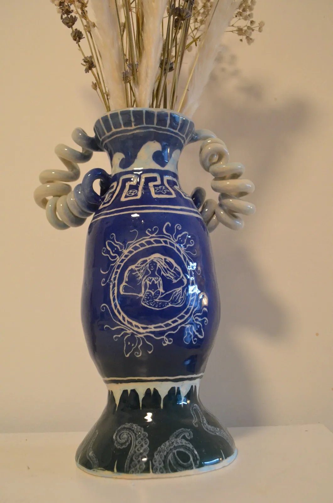 Blue ceramic amphora decorated with marine imagery